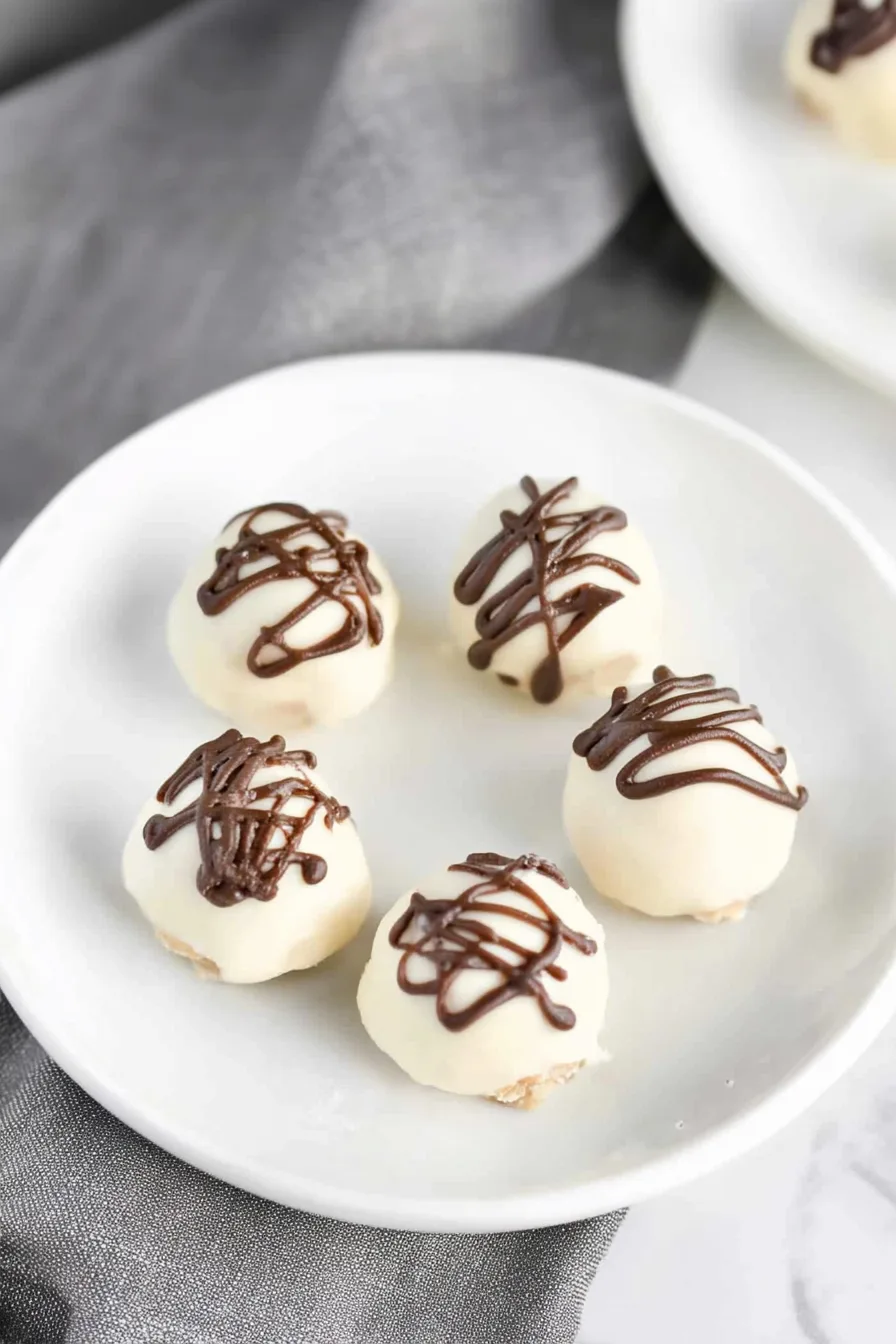 Plate of bite-sized dessert balls arranged neatly with a glossy finish.