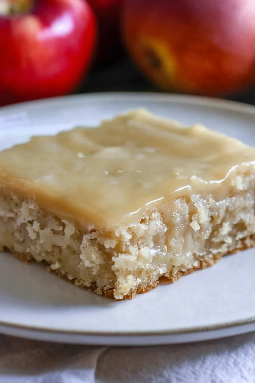 Golden sheet cake cut into squares and served on a platter.