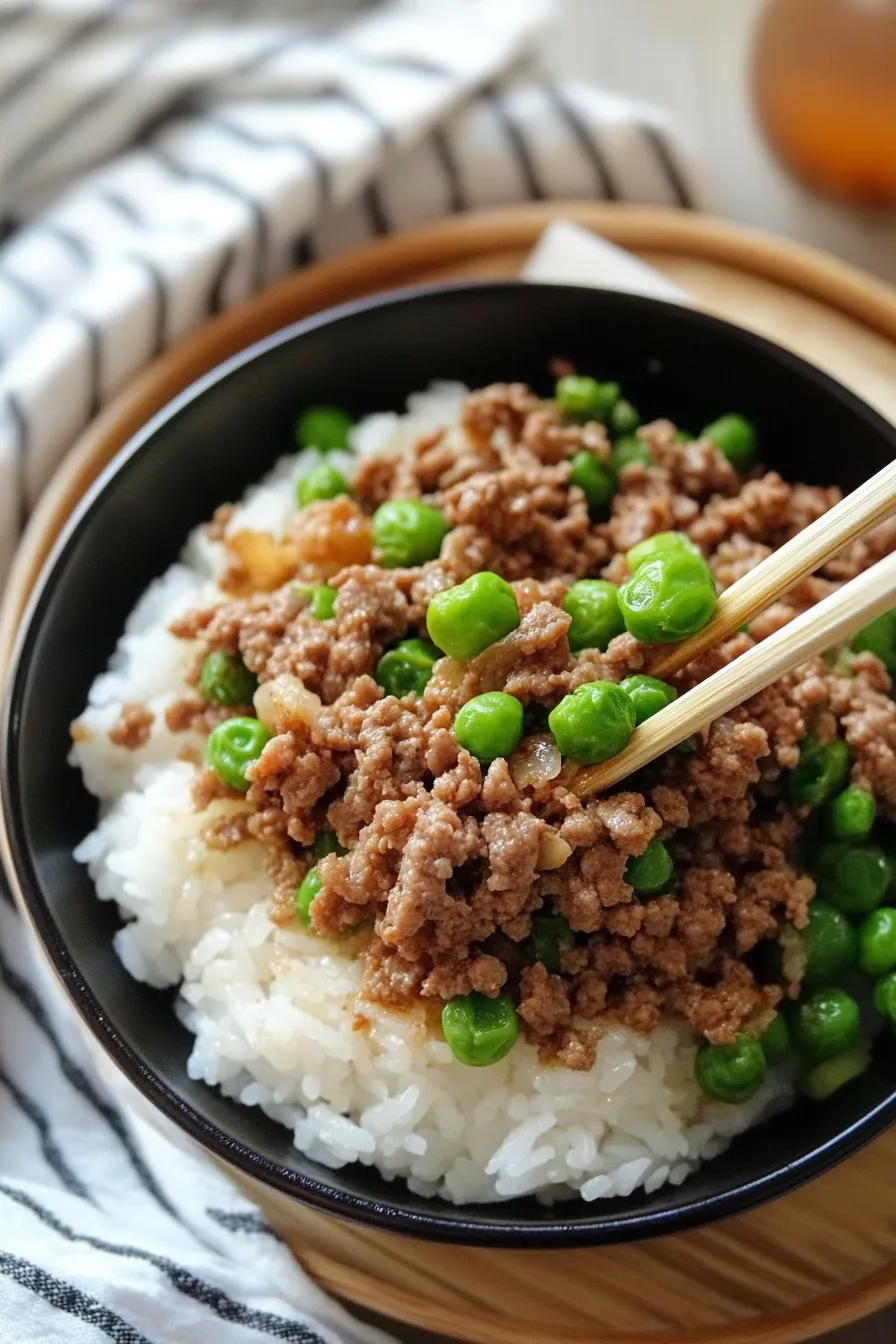 Overhead shot of a rice bowl garnished with sesame seeds and green onions