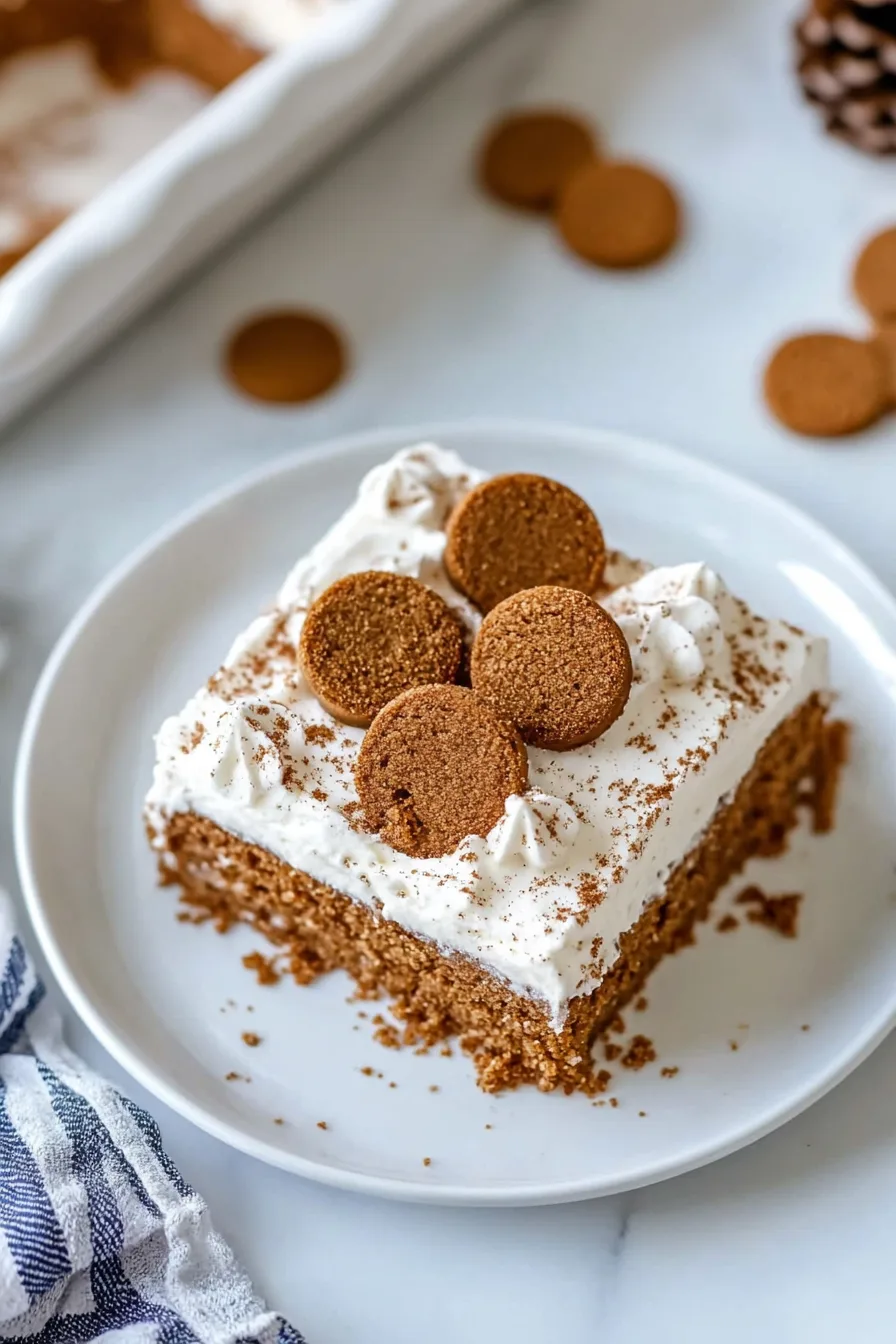 Rich holiday cake served on a white plate with a thick layer of frosting.