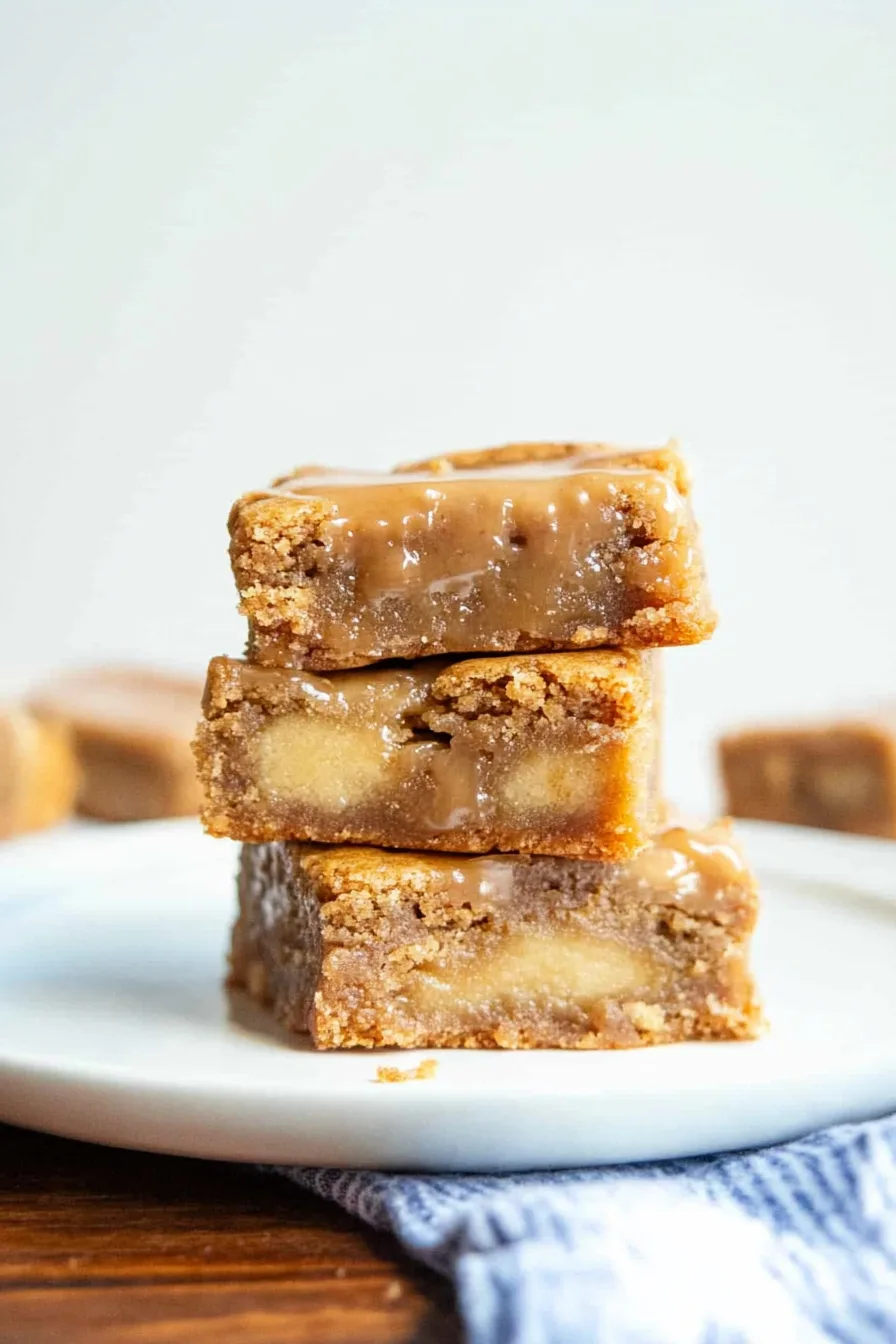 A rustic serving platter filled with glazed apple blondies, ready to share.