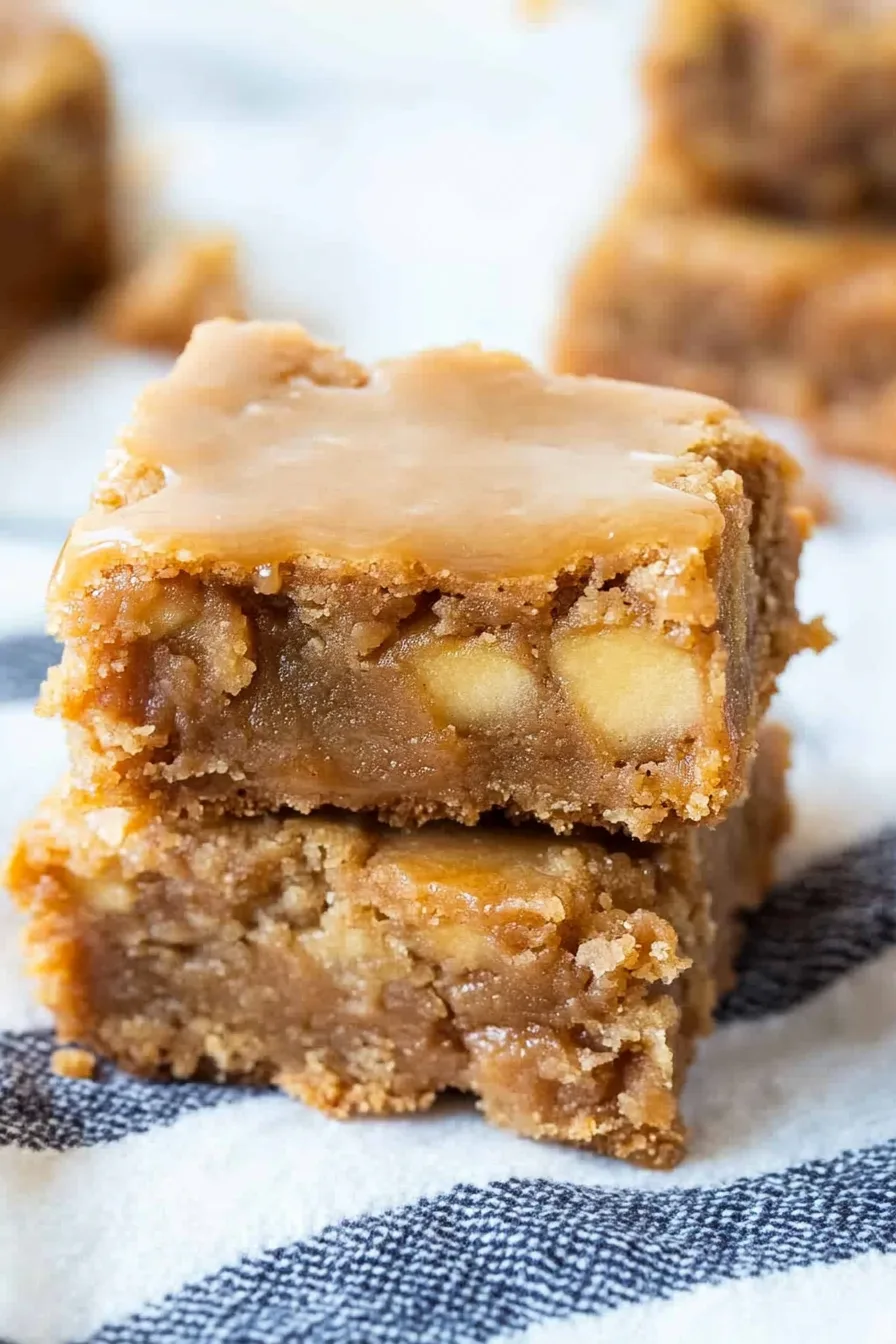 Golden blondie bars stacked neatly, showing their soft and chewy texture.