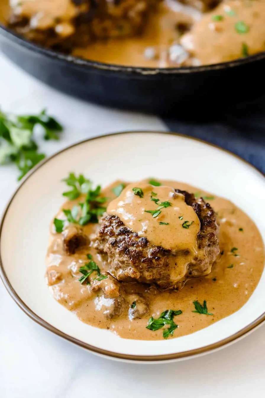 Juicy hamburger patties topped with rich onion gravy