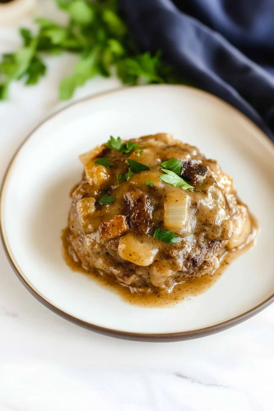 Tender beef patties smothered in savory gravy with onions on top