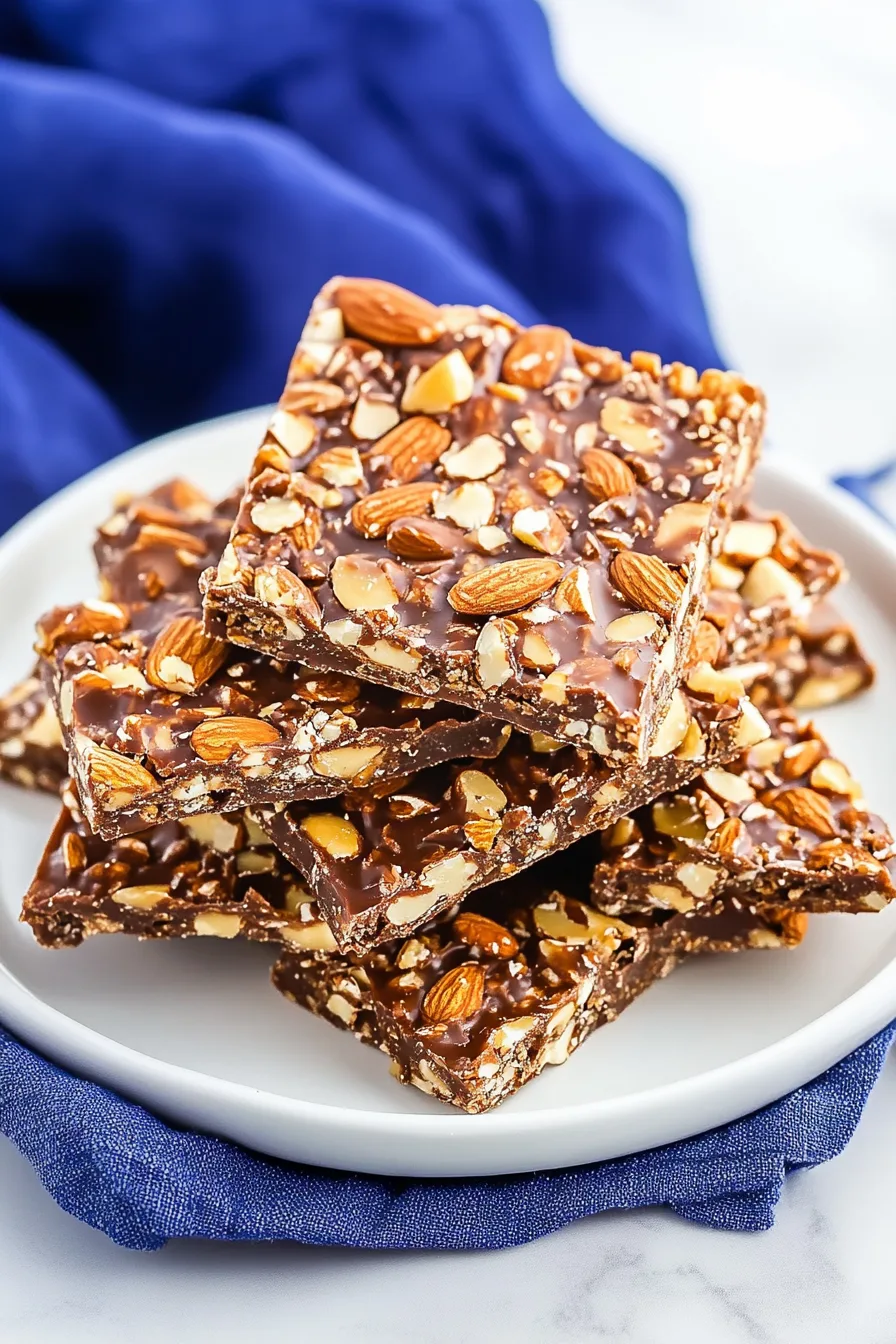 Broken pieces of buttery toffee coated in milk chocolate and sprinkled with almonds.