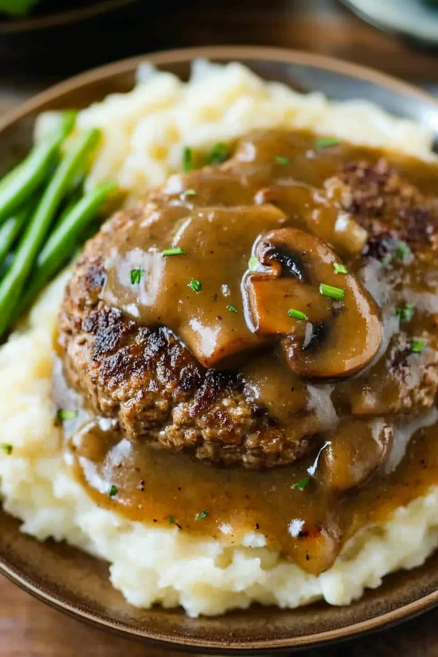 Hearty dinner plate with Salisbury-style beef patties and creamy mushroom sauce.