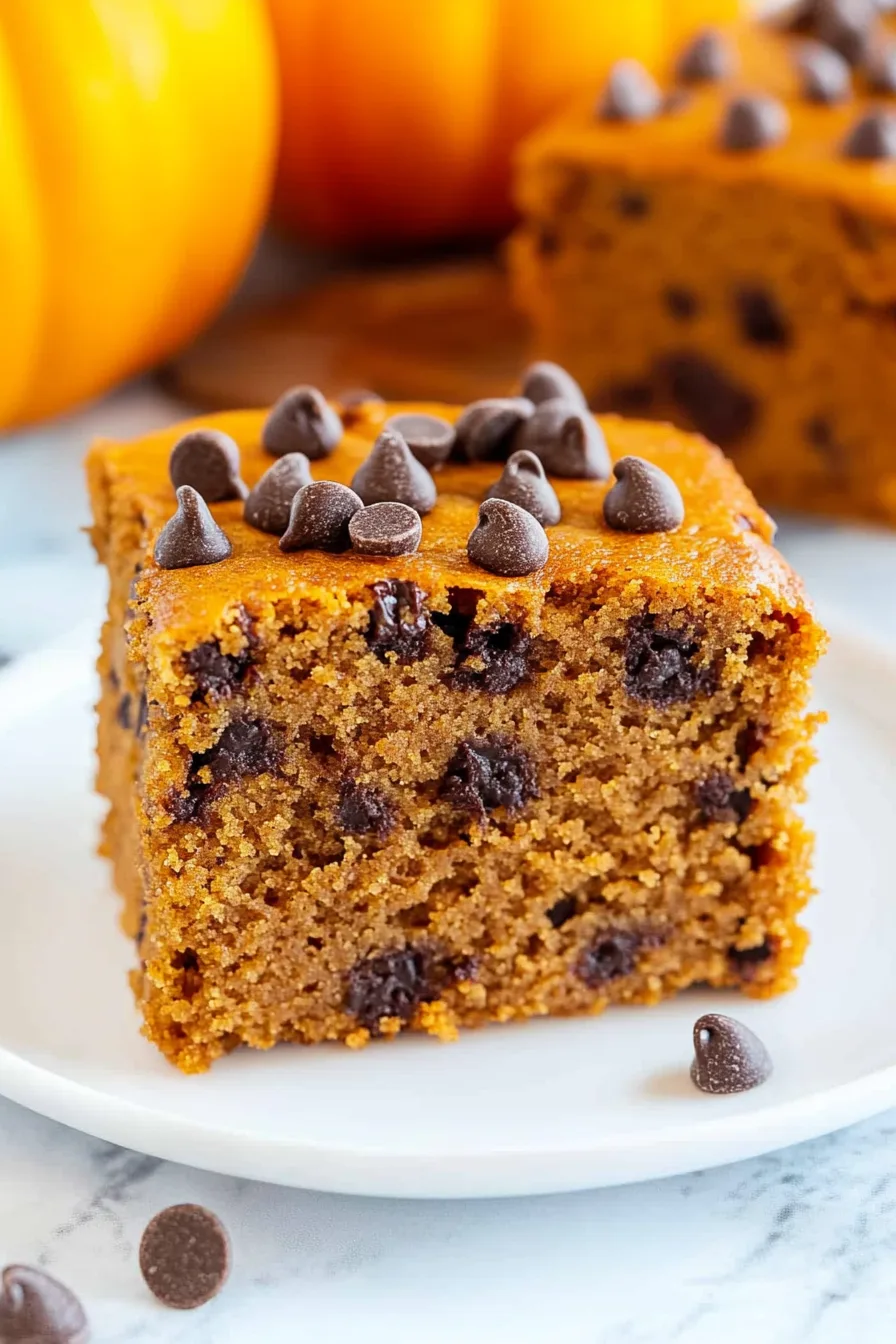 Close-up of fluffy pumpkin dessert with melty chocolate chips throughout.