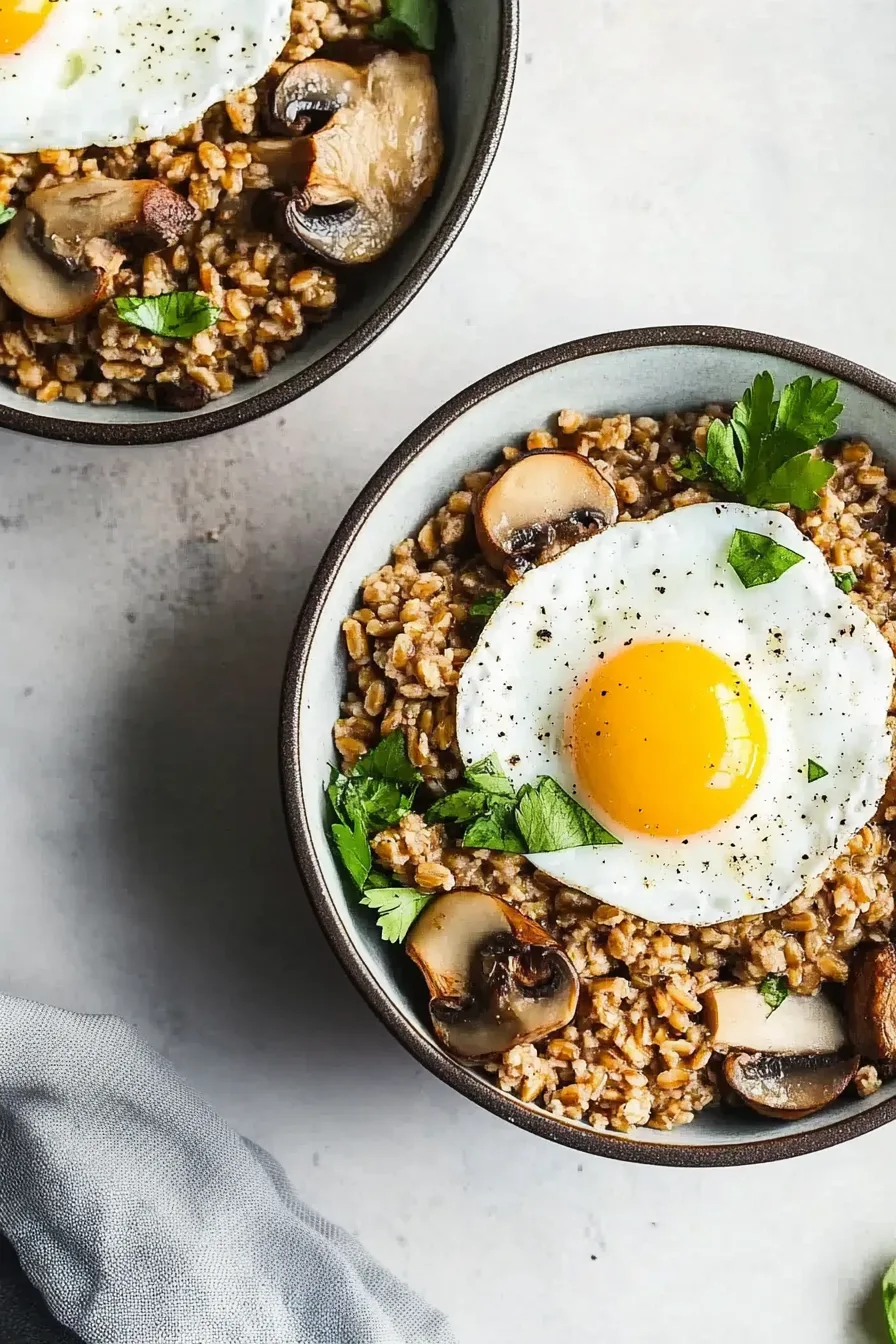 Wholesome grain bowl garnished with fresh parsley, mushrooms, and a sunny egg yolk.