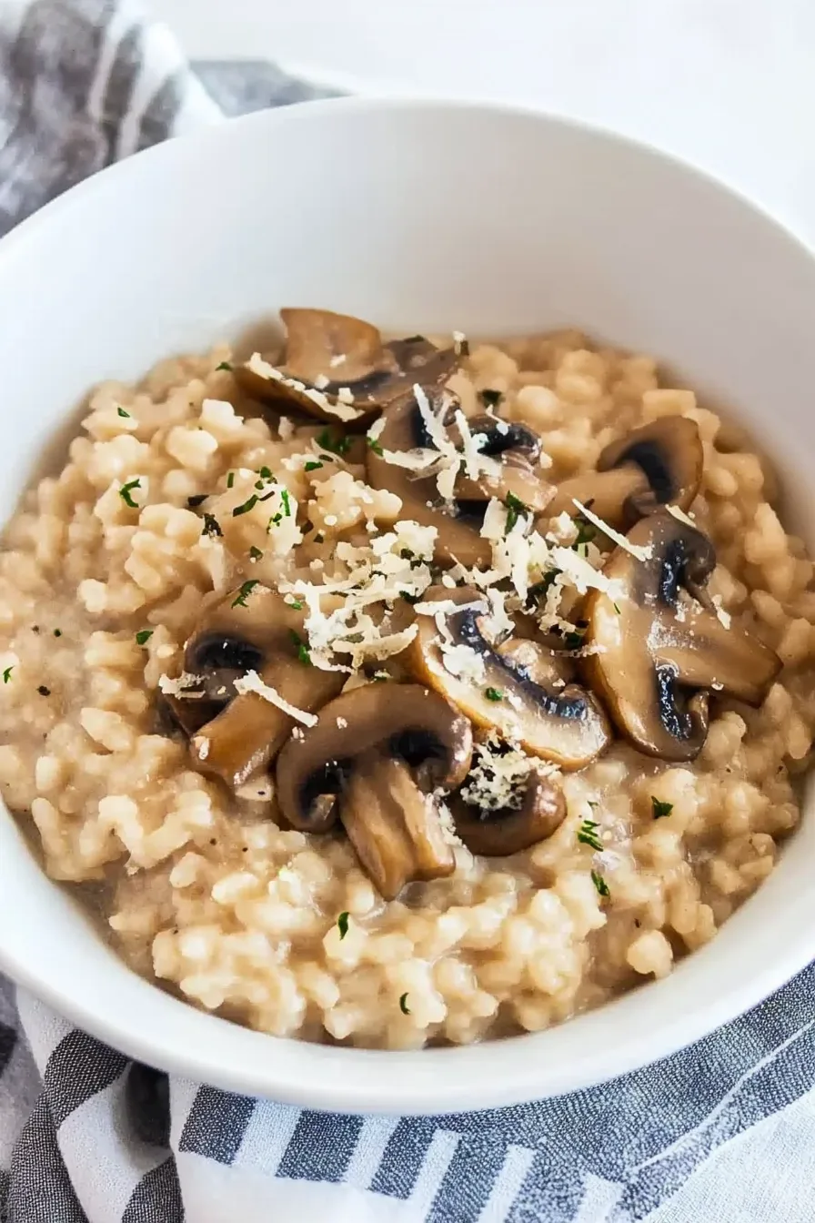 Creamy rice dish topped with sautéed mushrooms and grated cheese.