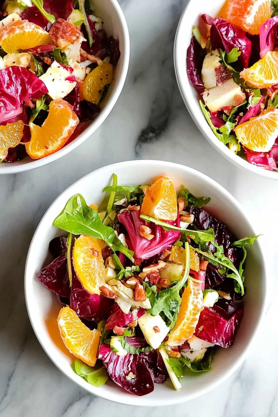 Colorful mix of greens and citrus segments tossed with light dressing and herbs.