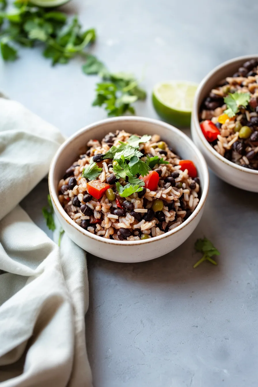 Rustic bowl of black beans and rice, highlighting the rich, savory texture of the dish.