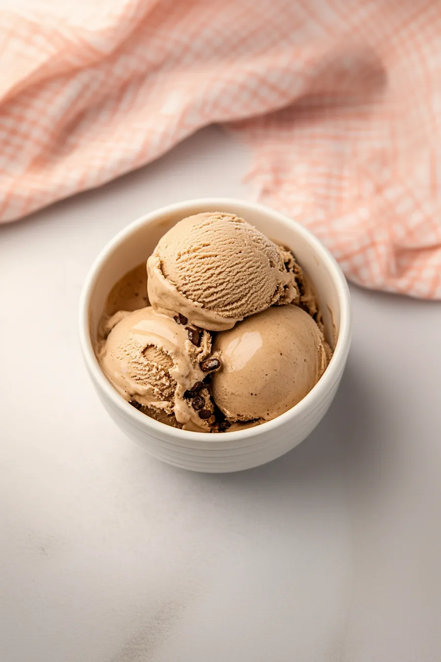 Velvety ice cream scoops with rich color and subtle shine, placed in a minimalist setting