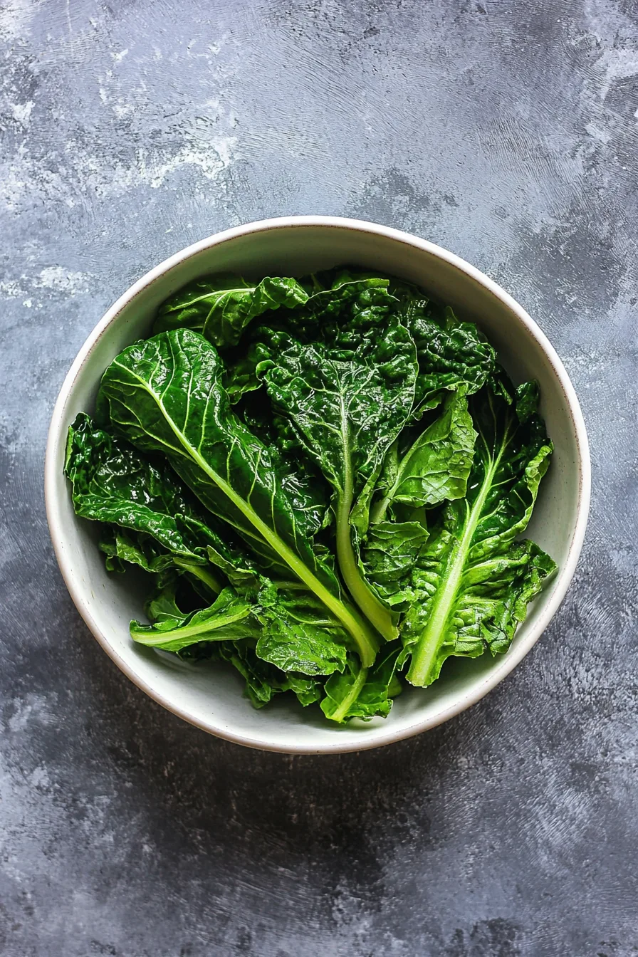 Serving of warm, seasoned greens in a rustic dish.