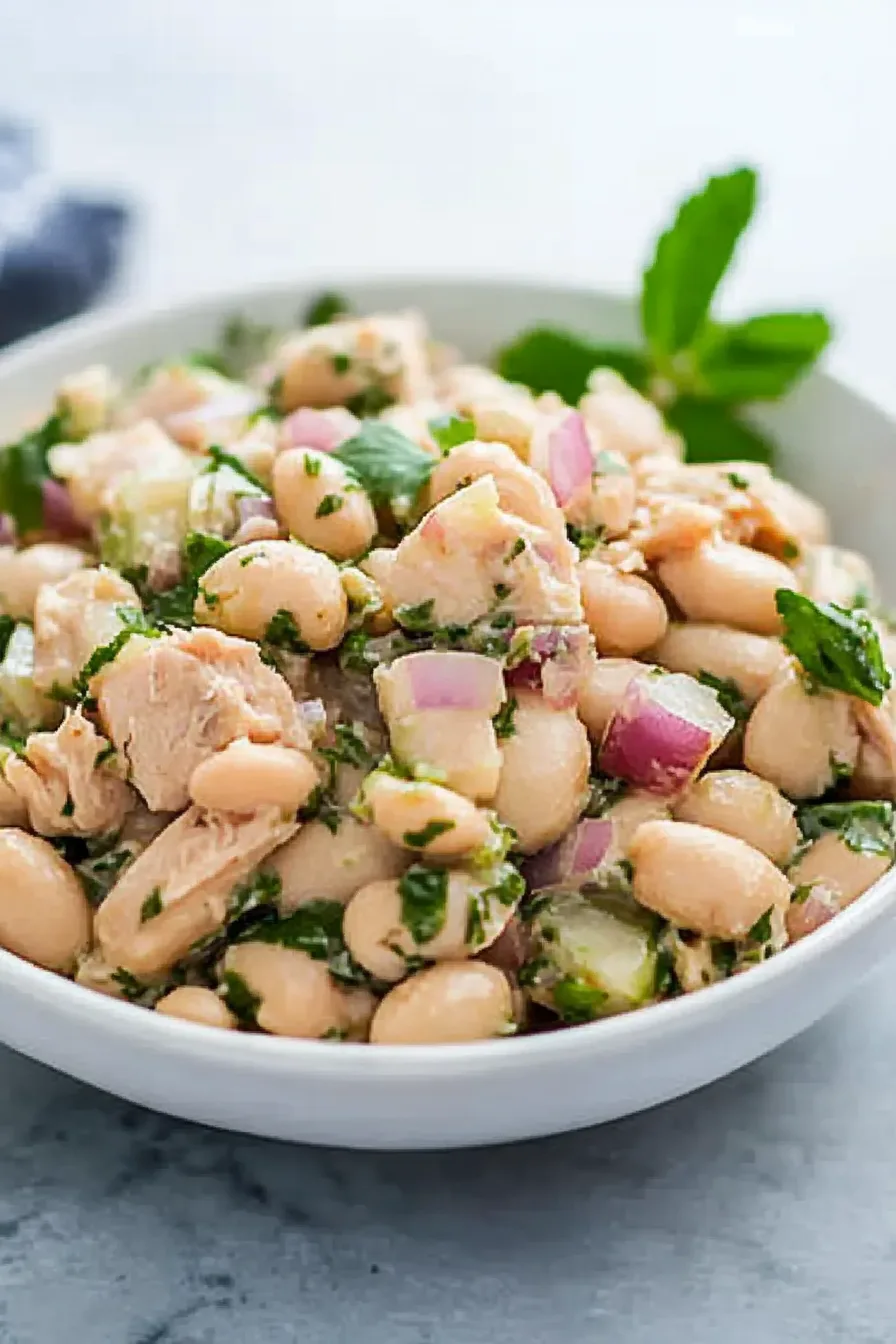 Close-up of a chilled salad with leafy greens and a simple vinaigrette.