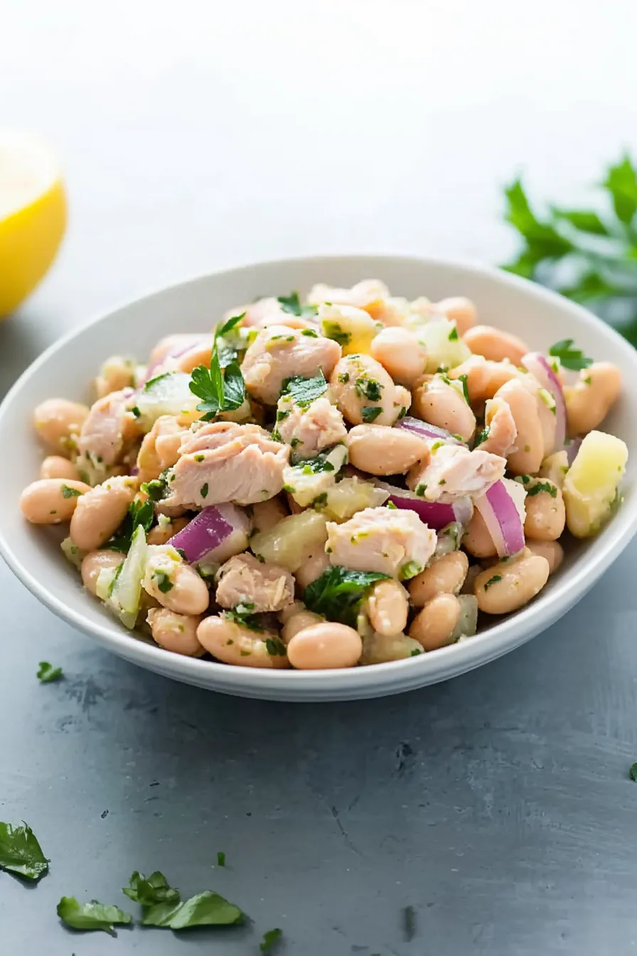 A bright and fresh salad featuring beans, herbs, and sliced vegetables.