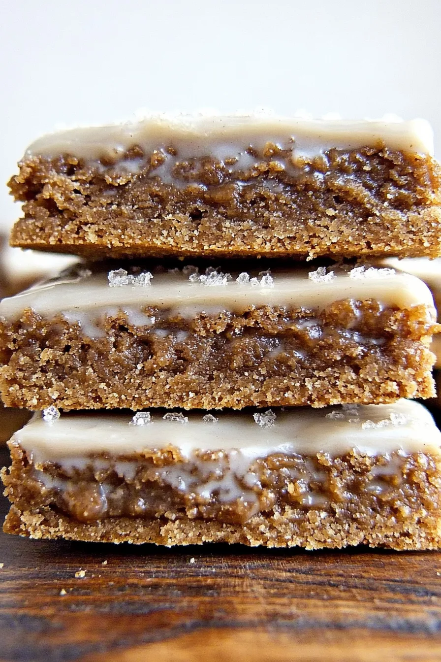 Spiced dessert bars topped with a smooth glaze and cut into neat squares.
