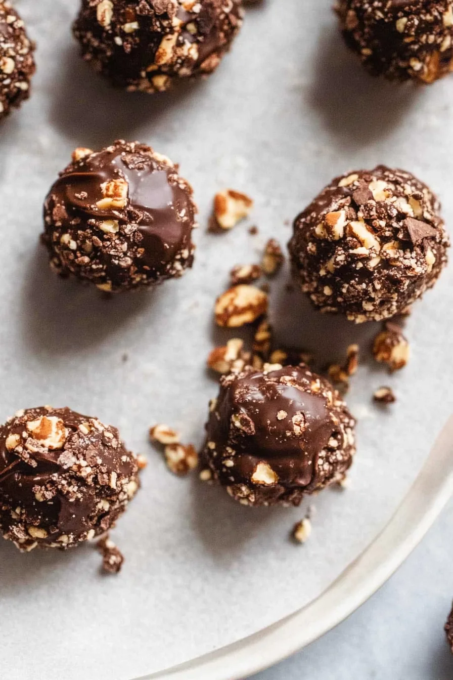 Overhead shot of homemade vegan Ferrero Rocher arranged in a gift box, ready for sharing.