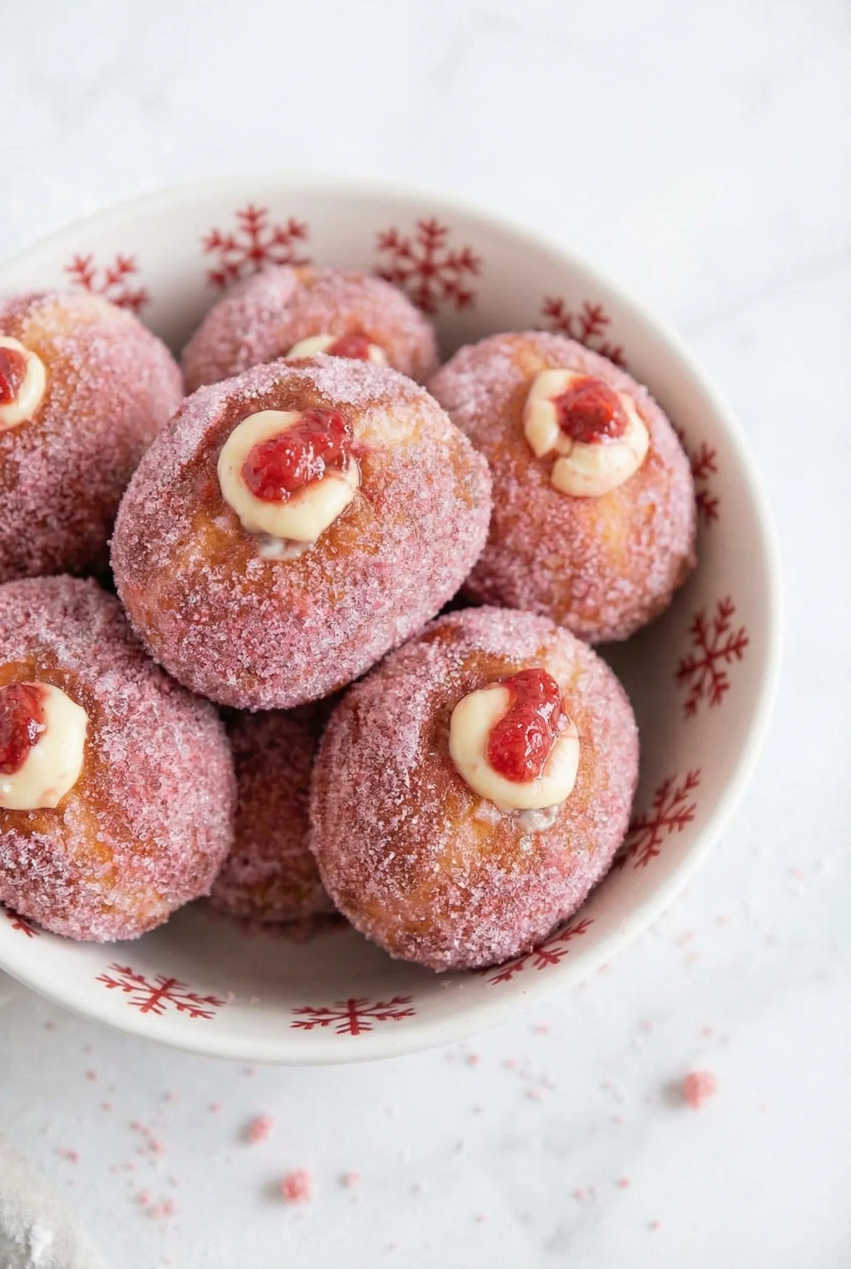 Final plated shot of a gourmet doughnut, highlighting texture, filling, and vibrant topping.