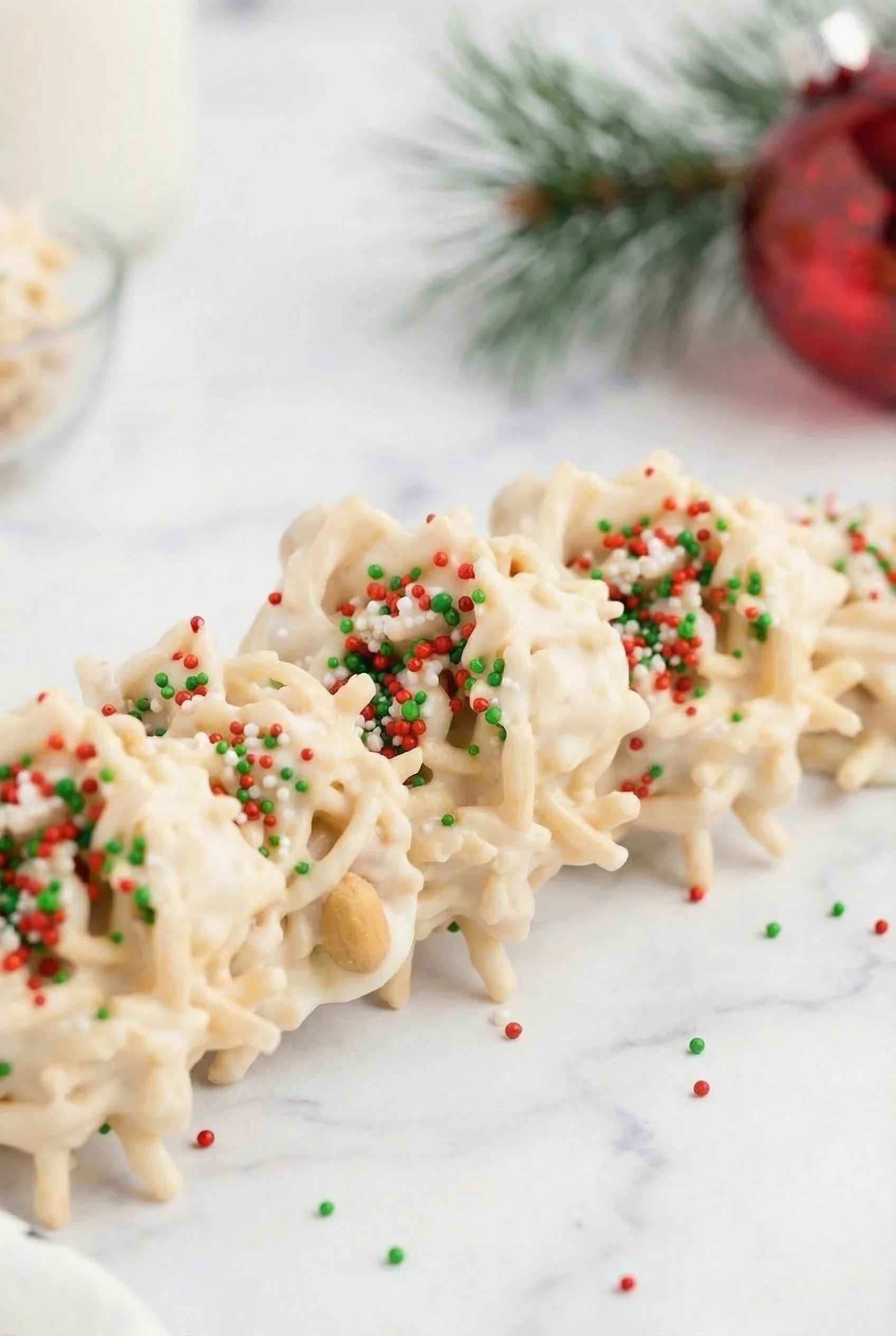 Overhead view of pale, bite-sized candy pieces set on parchment.