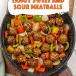 skillet filled with sweet and sour meatballs mixed with bell peppers in rich tangy sauce