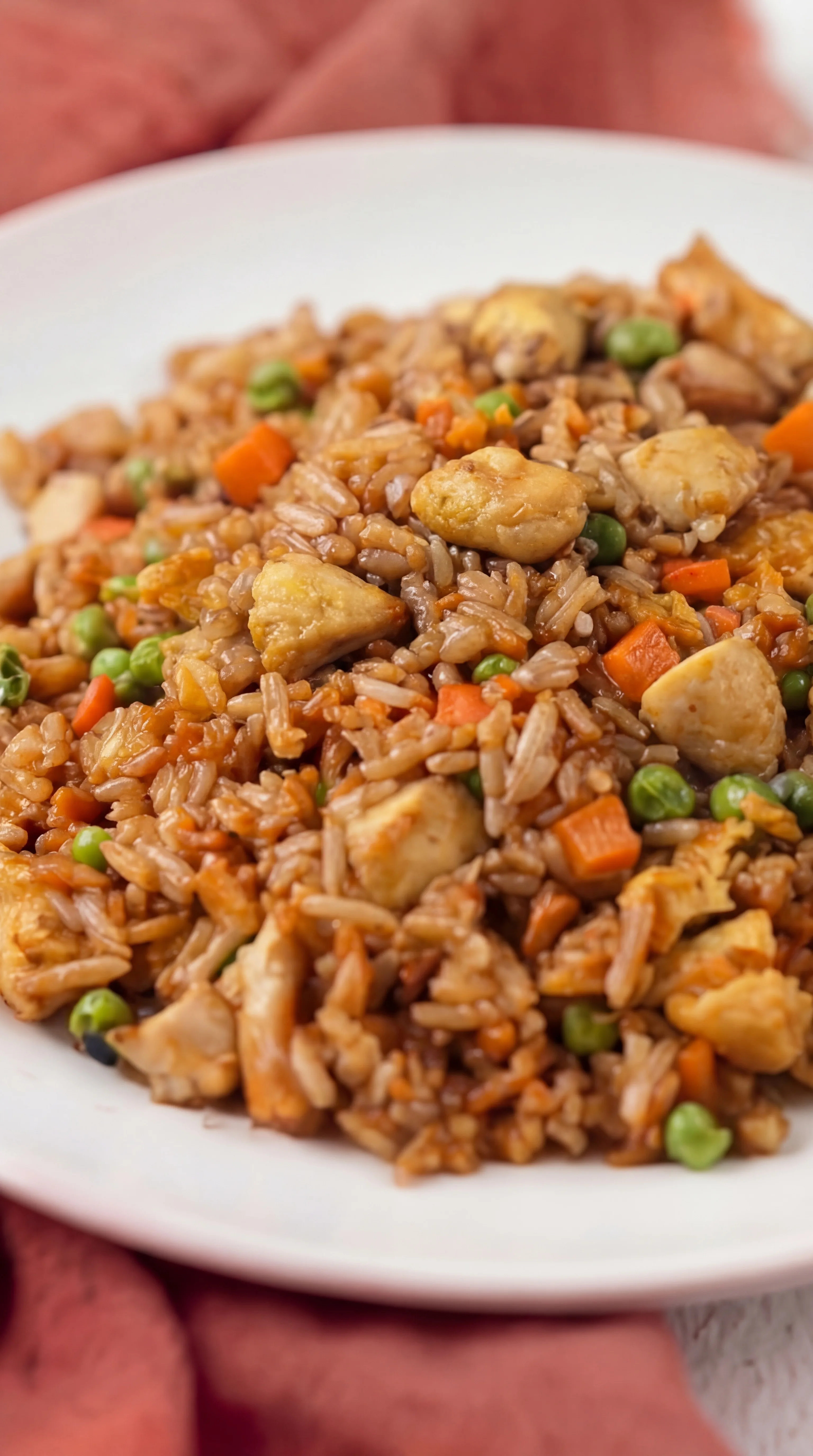 close-up of fried rice with tender chicken pieces peas carrots and fluffy seasoned rice