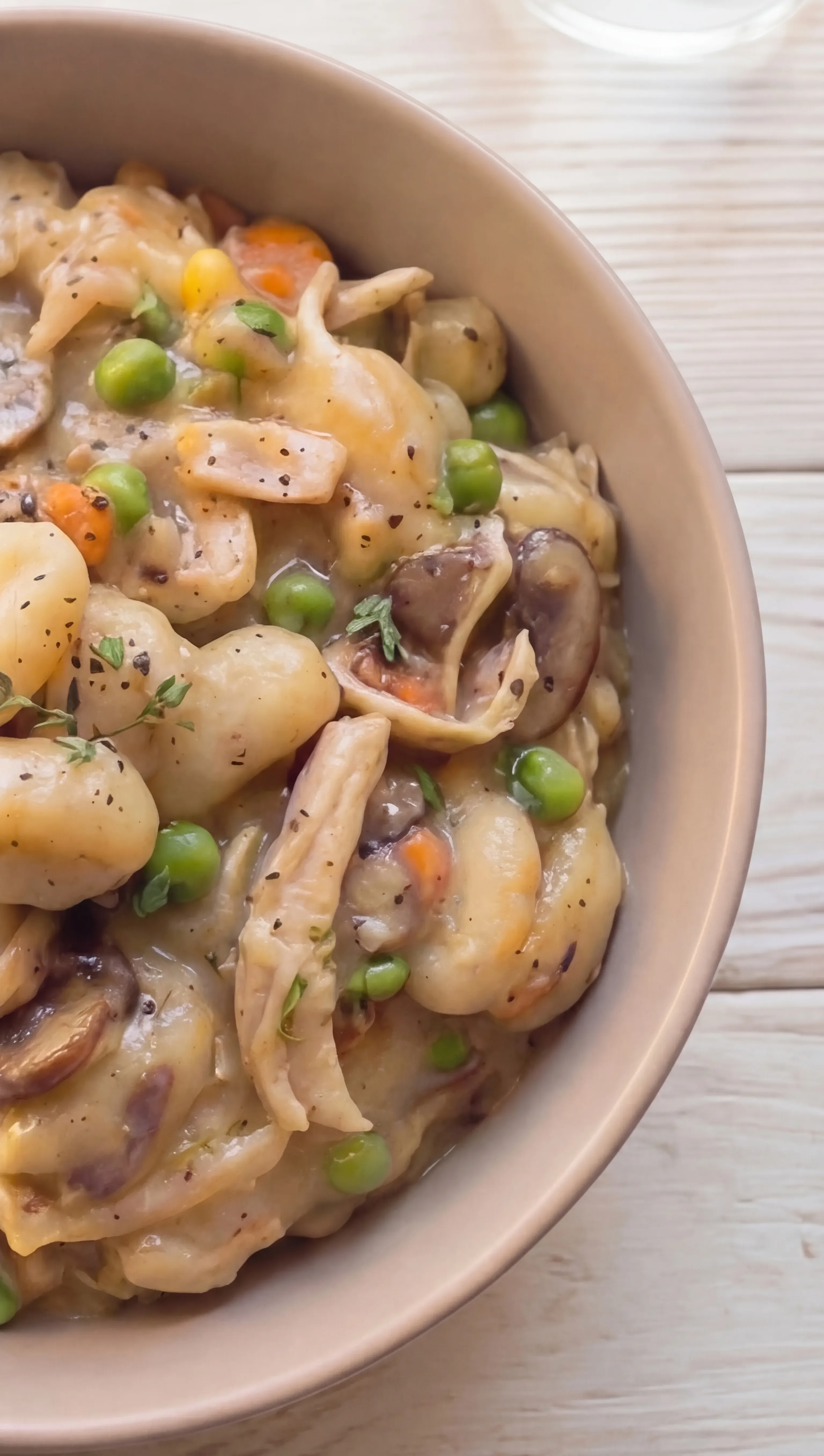 creamy chicken pot pie style gnocchi with mushrooms carrots peas and herbs in rich sauce